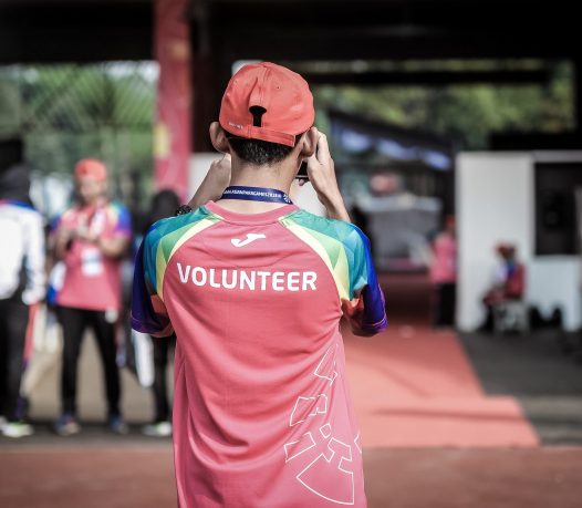 child holding camera taking pictures volunteer