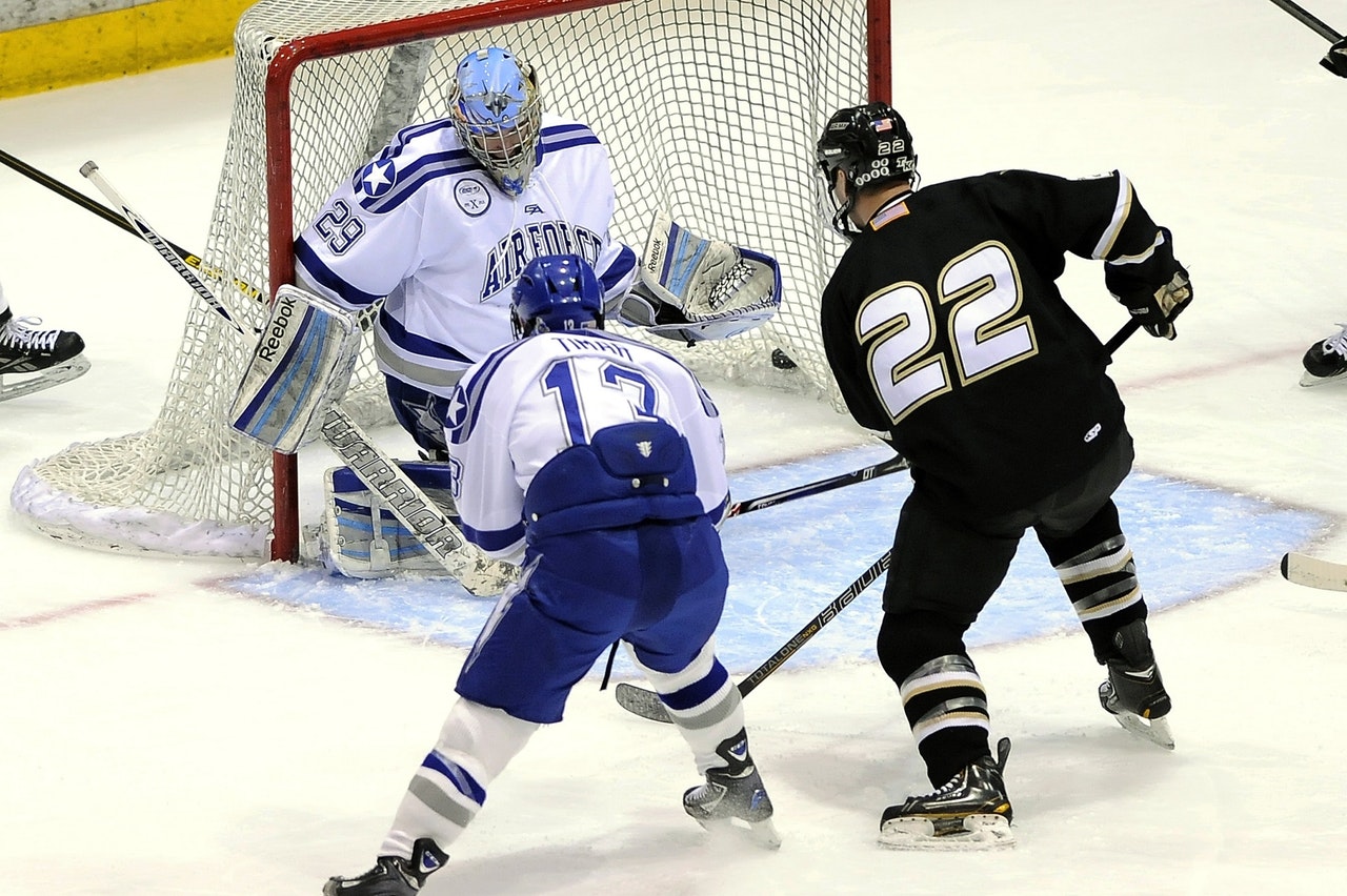 active arena 2 teams playing ice hockey with goal score