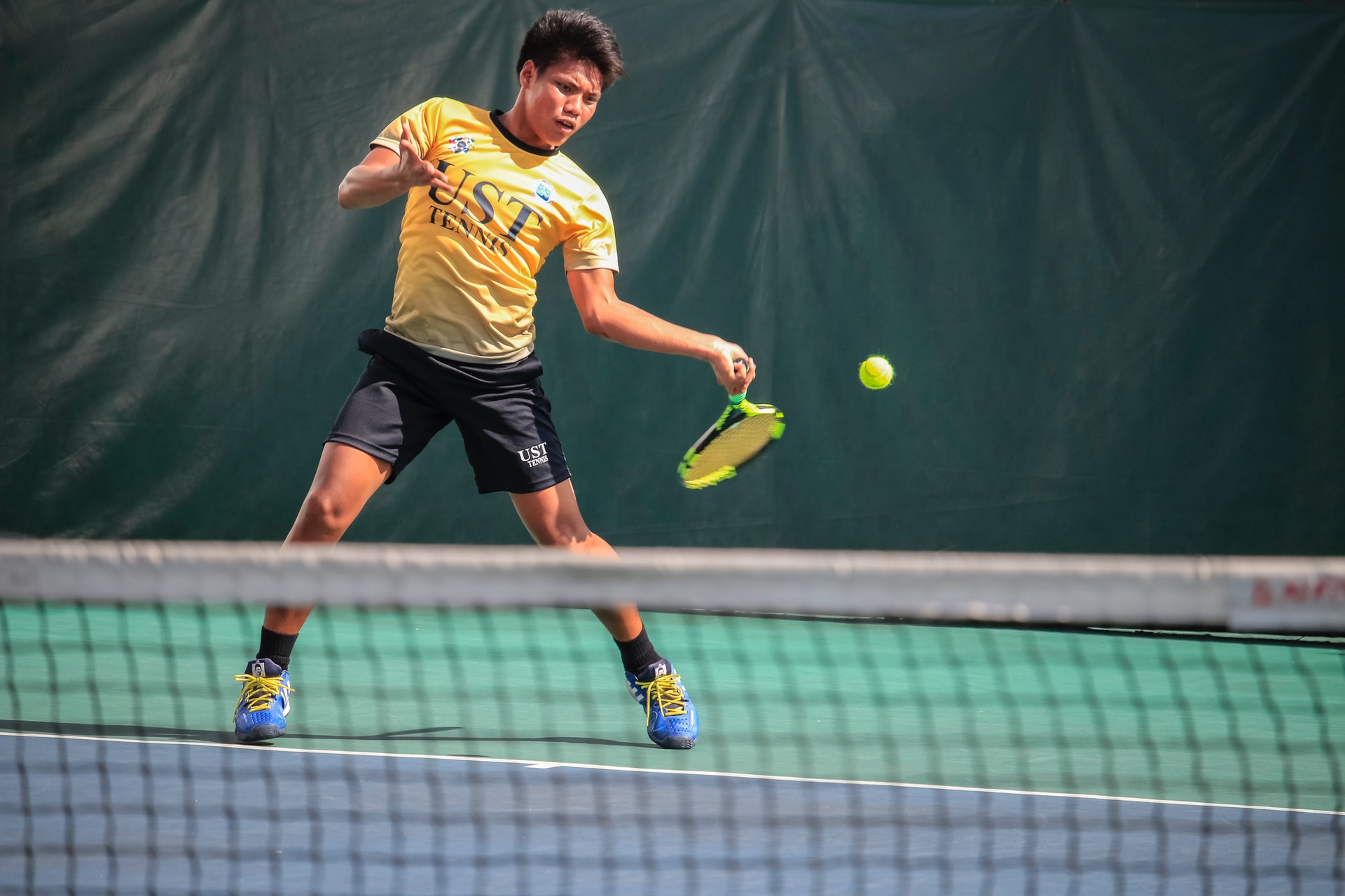 player hitting tennis ball back in motion