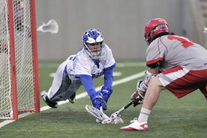 2 boys playing lacrosse in high school