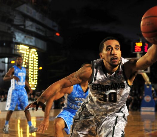 basketball mens with ball in hand lunging